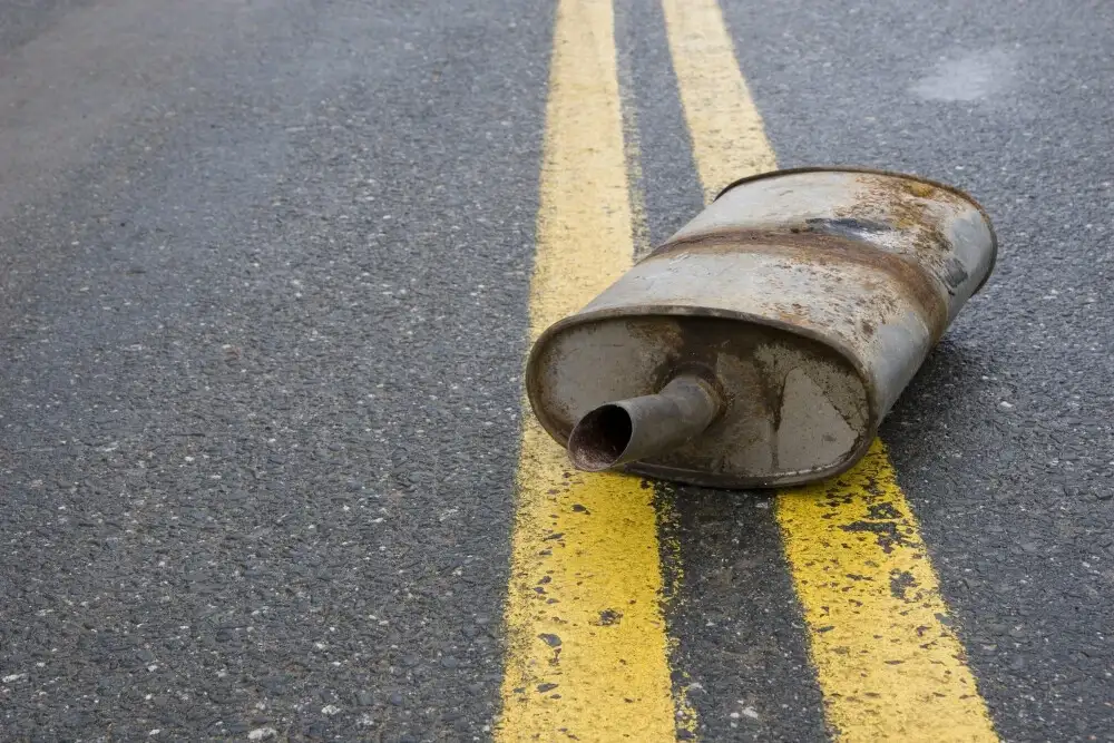 Who is responsible for road debris damage? A muffler on the road.